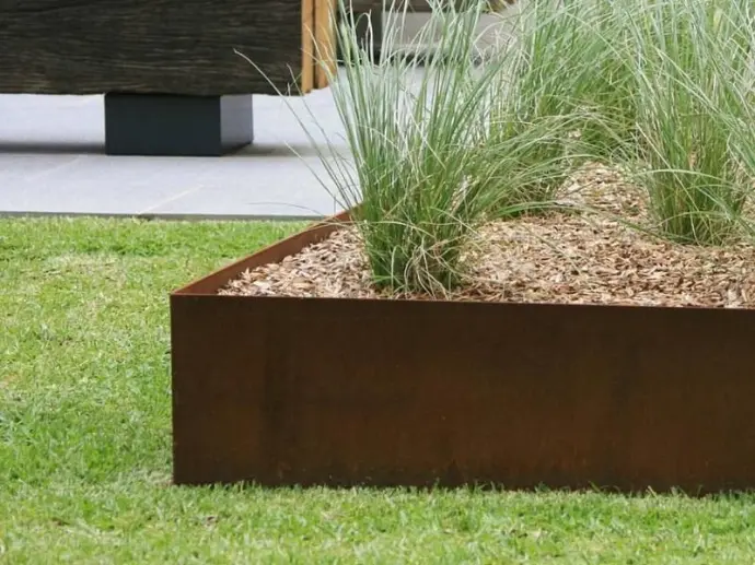 Slim profile steel wall saving space compared to bulky retaining wall blocks.
