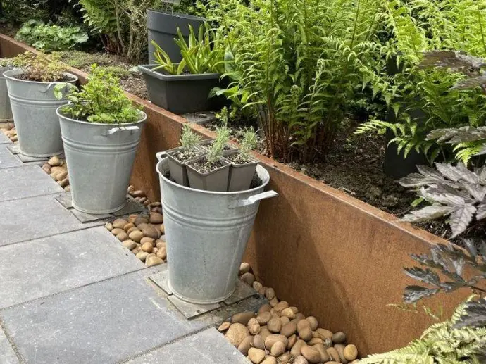 Weathering steel terrace outperforming traditional concrete block retaining walls.